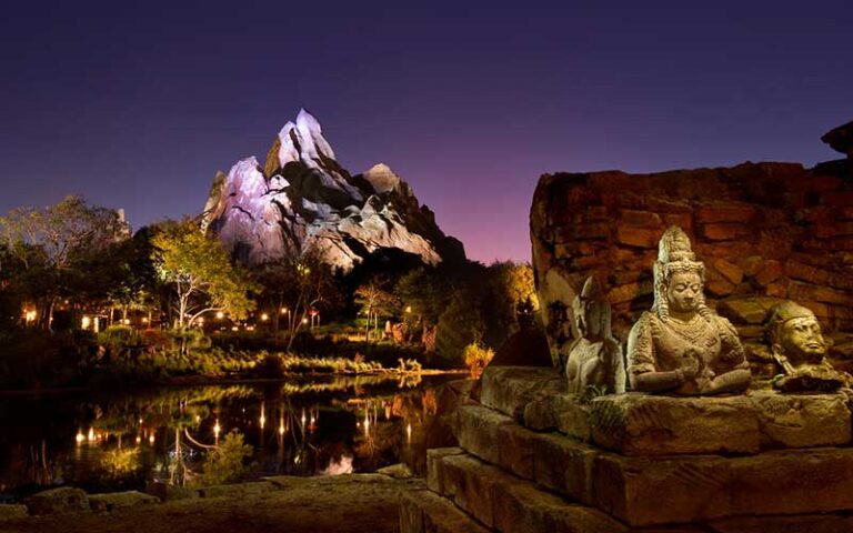 night view over water of everest ride on expedition everest legend of the forbidden mountain at animal kingdom walt disney world resort orlando