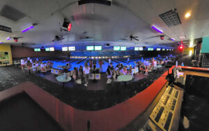 panoramic view of bowling alley with low lights and bowlers at anastasia lanes st augustine