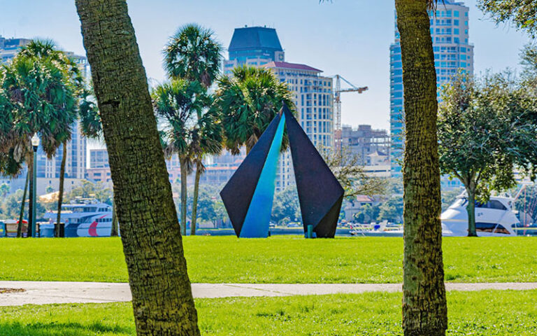 park area with metal sculpture and city skyline in background at vinoy park st pete