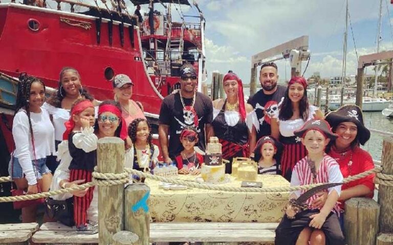 party group at table on dock with ship at captain memos pirate cruise clearwater