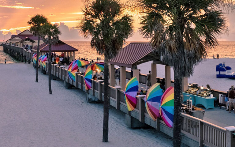 pier at sunset with rainbow umbrellas and vendors at pier 60 park clearwater beach