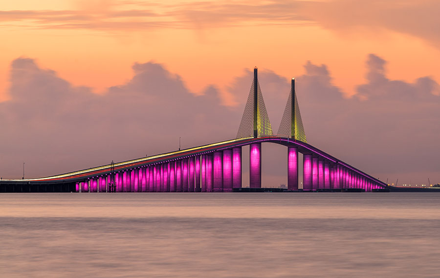 pink sky sunset with magenta lighted sunshine skyway bridge over tampa bay st pete
