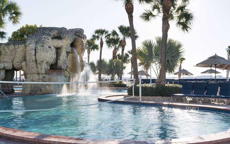 pool area with polo net loungers and rock with waterfall at clearwater beach marriott suites on sand key