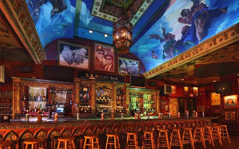 rustic bar with row of stools and bluesy decor at house of blues restaurant bar at disney springs orlando