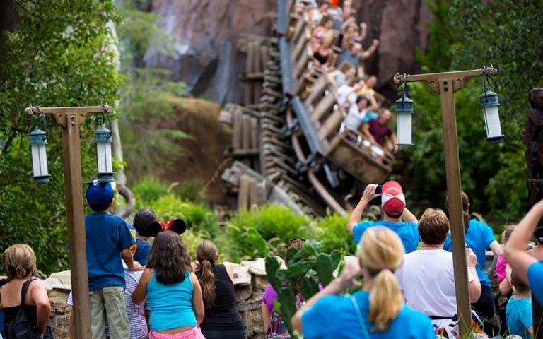 spectators watching coaster dive into cave on expedition everest legend of the forbidden mountain at animal kingdom walt disney world resort orlando