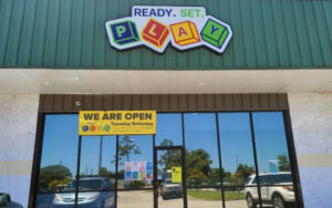 store front daytime with reflective windows and sign at ready set play st augustine
