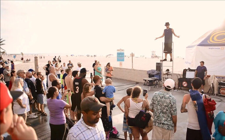 street performer on stilts with crowd at pier 60 park clearwater beach