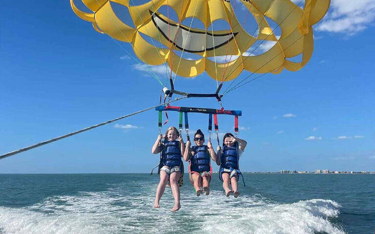 three girls on parasail at johns pass village boardwalk madeira beach