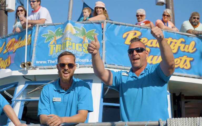 tour guides cheering standing with people on deck at the tropics boat tours clearwater beach
