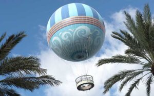 view from below of blue balloon ride with passengers at aerophile balloon ride at disney springs walt disney world resort orlando