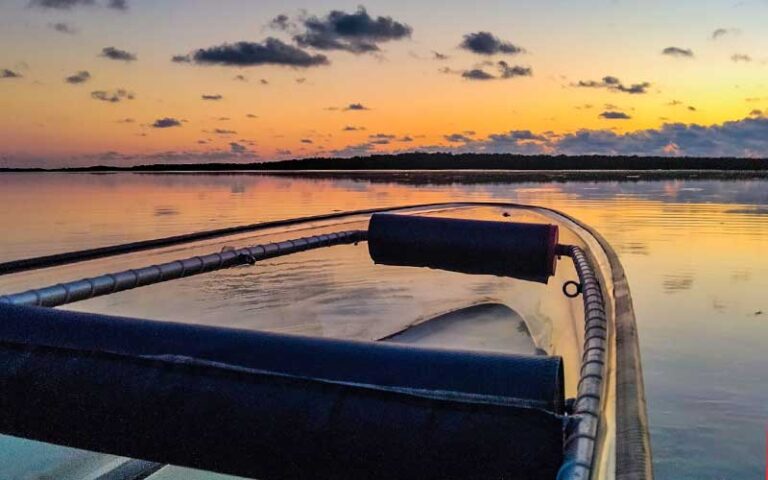 view from clear kayak of sunset across inlet with clouds at see through adventures st pete