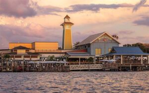 view from water of restaurant exterior at twilight at the boathouse at disney springs orlando