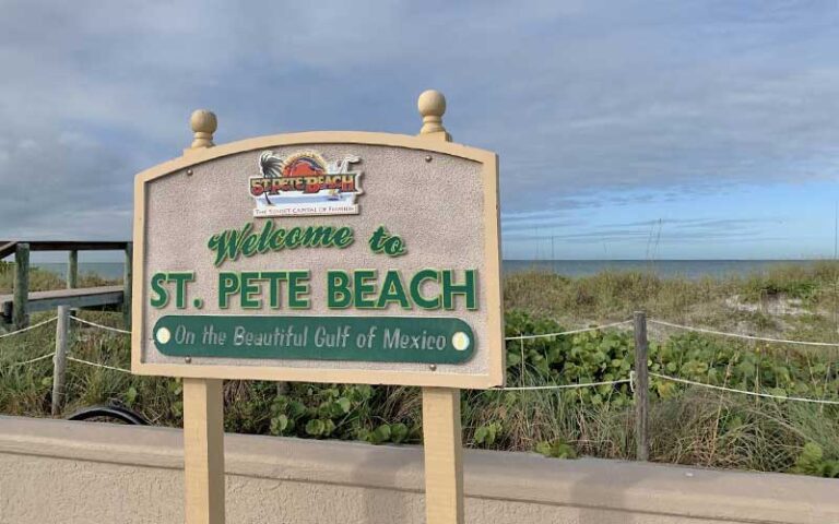 welcome sign with boardwalk and shrubs at st pete beach