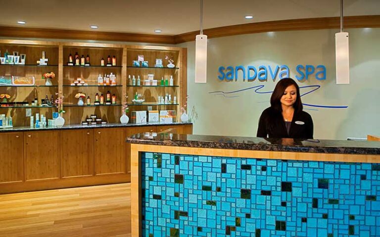 woman at spa desk with product shelves at hyatt regency clearwater beach resort and spa