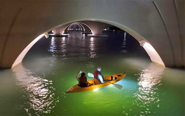 yellow kayak with two under bridge archways at sharkeys glass bottom tours st pete beach