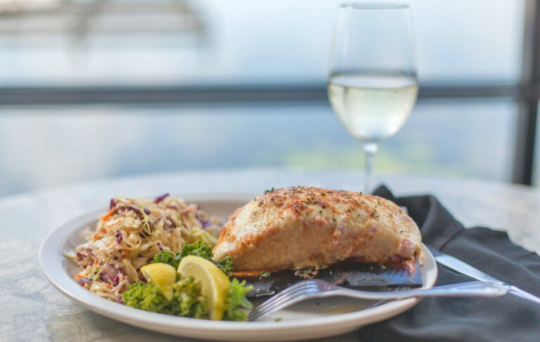 baked fish entree with sides and white wine at harborside winter haven