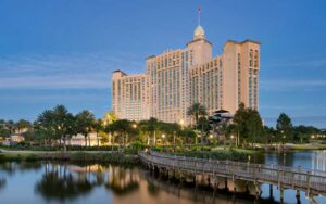 dusk view of high rise hotel with lake and boardwalk at jw marriott orlando grande lakes