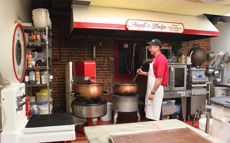 employee stirring chocolate in factory kitchen area at angell phelps chocolate factory daytona beach