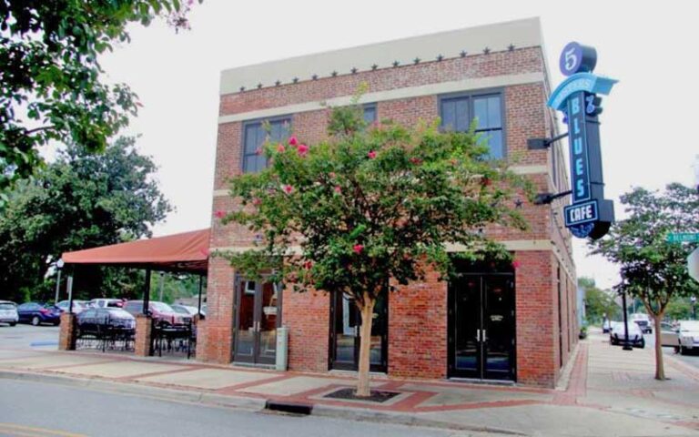 exterior of restaurant with red brick and patio at five sisters blues cafe pensacola