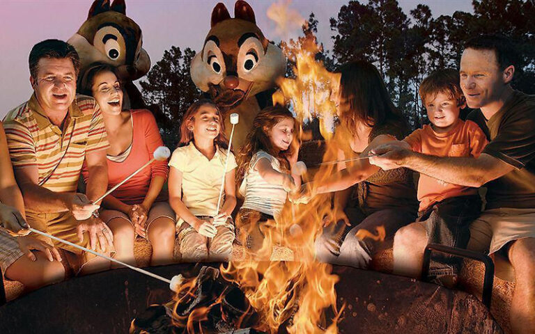 families roasting marshmallows with chip and dale characters at cabins at fort wilderness resort walt disney world orlando