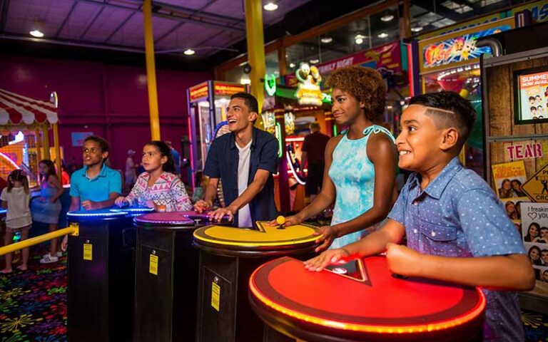 family playing team arcade game at daytona lagoon daytona beach