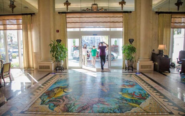 family walking into lobby at lago mar beach resort club fort lauderdale