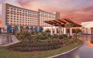 high rise hotel with entrance and sunset sky at universals endless summer resort dockside inn suites orlando