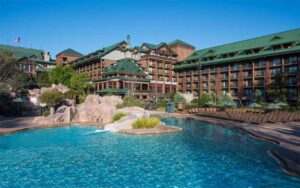 hotel exterior from pool with slide at wilderness lodge walt disney world resort orlando