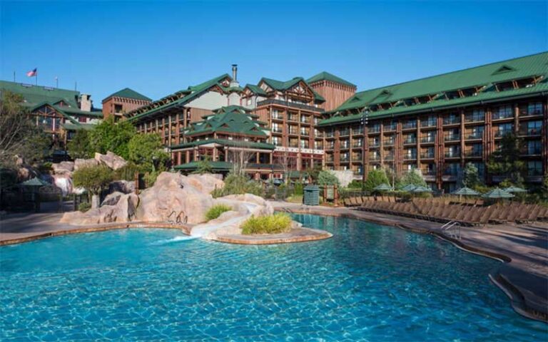 hotel exterior from pool with slide at wilderness lodge walt disney world resort orlando