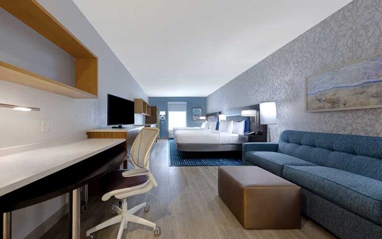 king bed suite with sofa and desk at home2 suites by hilton orlando international drive south