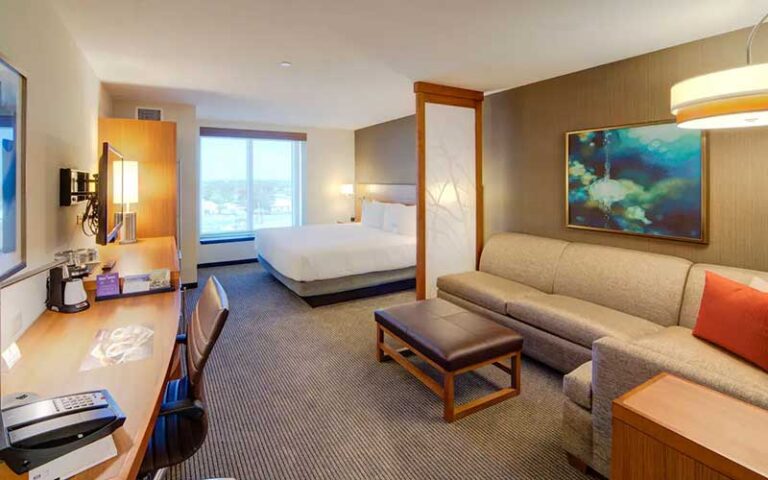 king bed suite with sofa at hyatt place pensacola airport