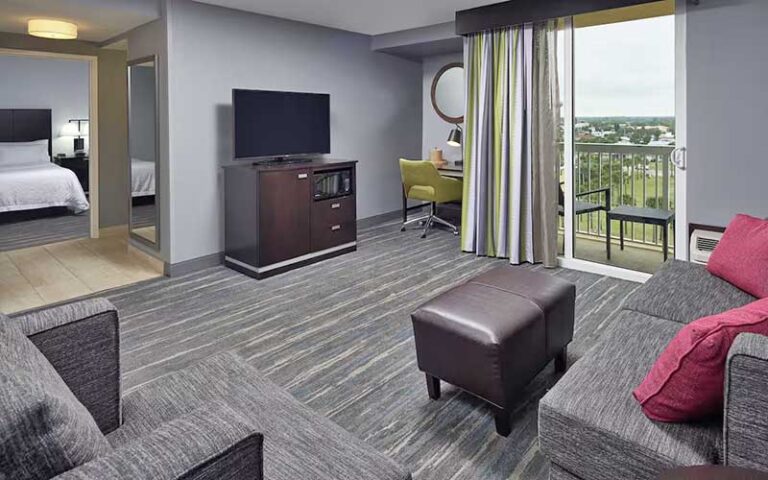 living room area with balcony at hampton inn daytona beach beachfront