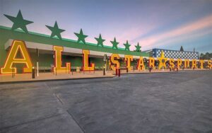 long building hotel entrance with resort sign letters at all star sports resort walt disney world orlando