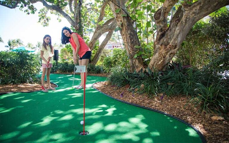 mom and daughter playing mini golf at lago mar beach resort club fort lauderdale