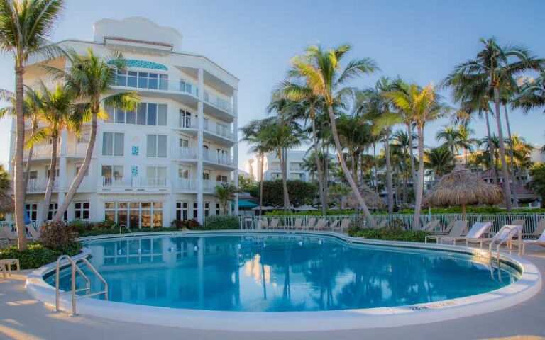 olympic size round pool with hotel building at lago mar beach resort club fort lauderdale