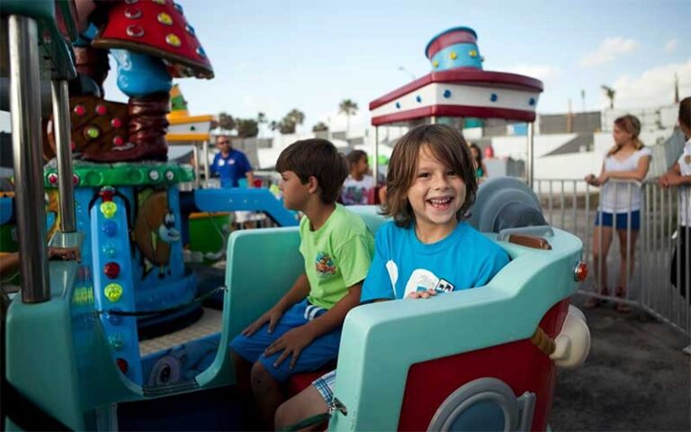smiling boy on carousel ride at daytona beach boardwalk amusements
