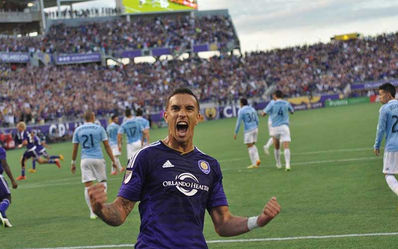 soccer player cheering on field at camping world stadium orlando
