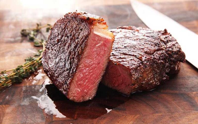 steak cut with knife on board at the fire restaurant winter haven