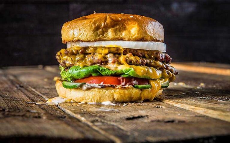 steak deluxe burger on carving board at the fire restaurant winter haven