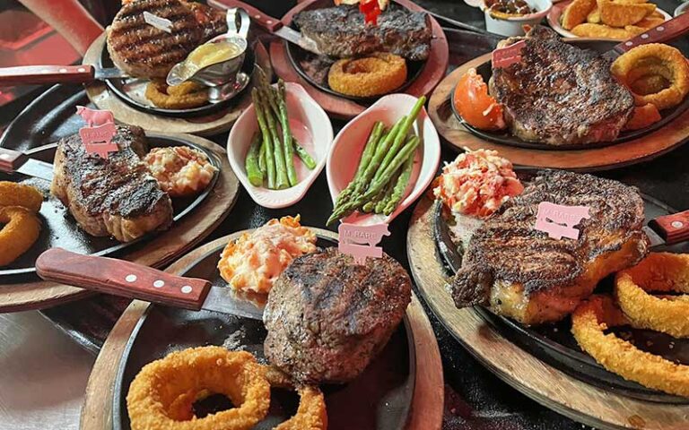 tabletop with several steak entrees at mcguires irish pub pensacola