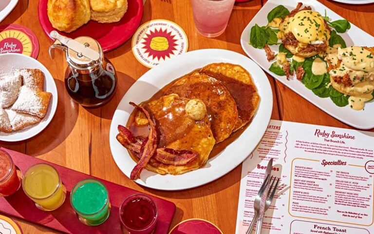 view from above of tabletop with breakfast entrees and menu at ruby slipper pensacola