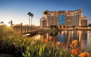 view over lake with flowers of tower hotel building at coronado springs resort walt disney world orlando