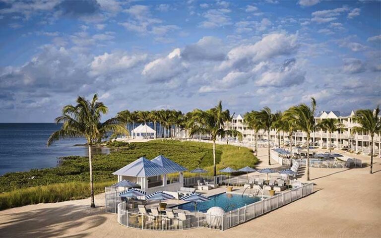 aerial view of resort along beach with cloudy sky at isla bella beach resort marathon fl keys
