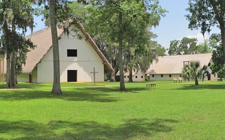 spanish colonial style buildings with expanse of green grass at mission san luis tallahassee