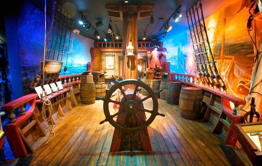 ship deck stage with colorful lights and exhibits at st augustine pirate treasure museum