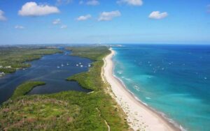 aerial view of coastline with boats on inlet and beach martin county florida