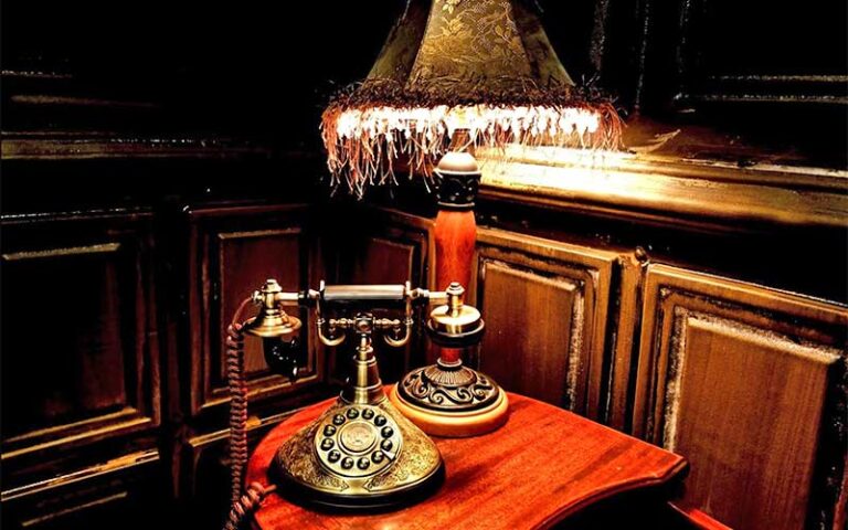 antique lamp and rotary phone on table at the ocala escape