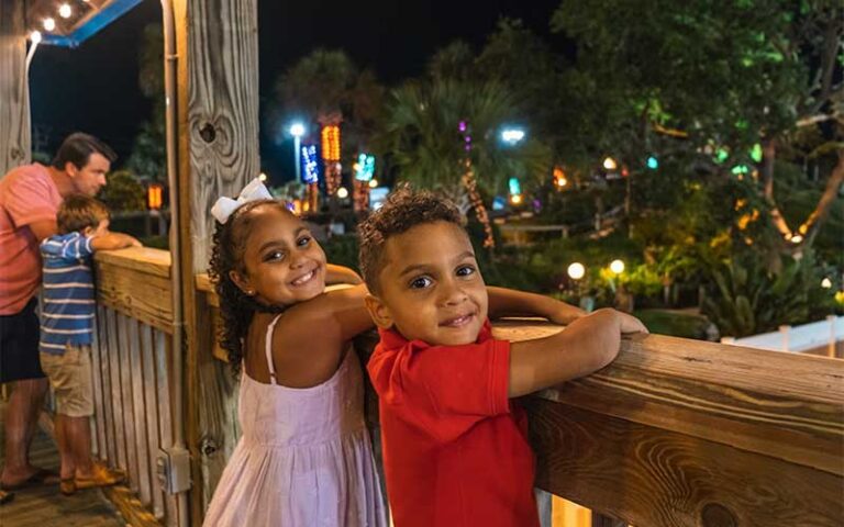 kids watching people putt at night at coconut creek family fun park panama city beach