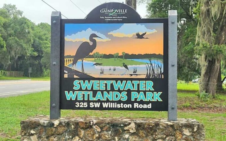 roadside sign with stone base and scenic graphic at sweetwater wetlands park gainesville