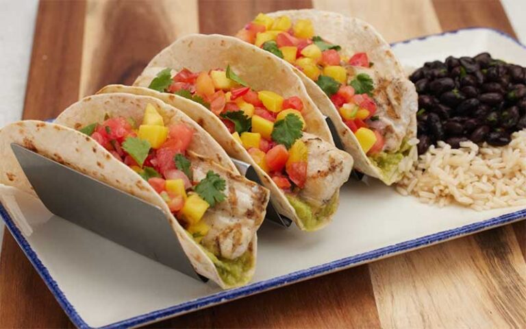 tropical taco trio on plate with sides at margaritaville panama city beach
